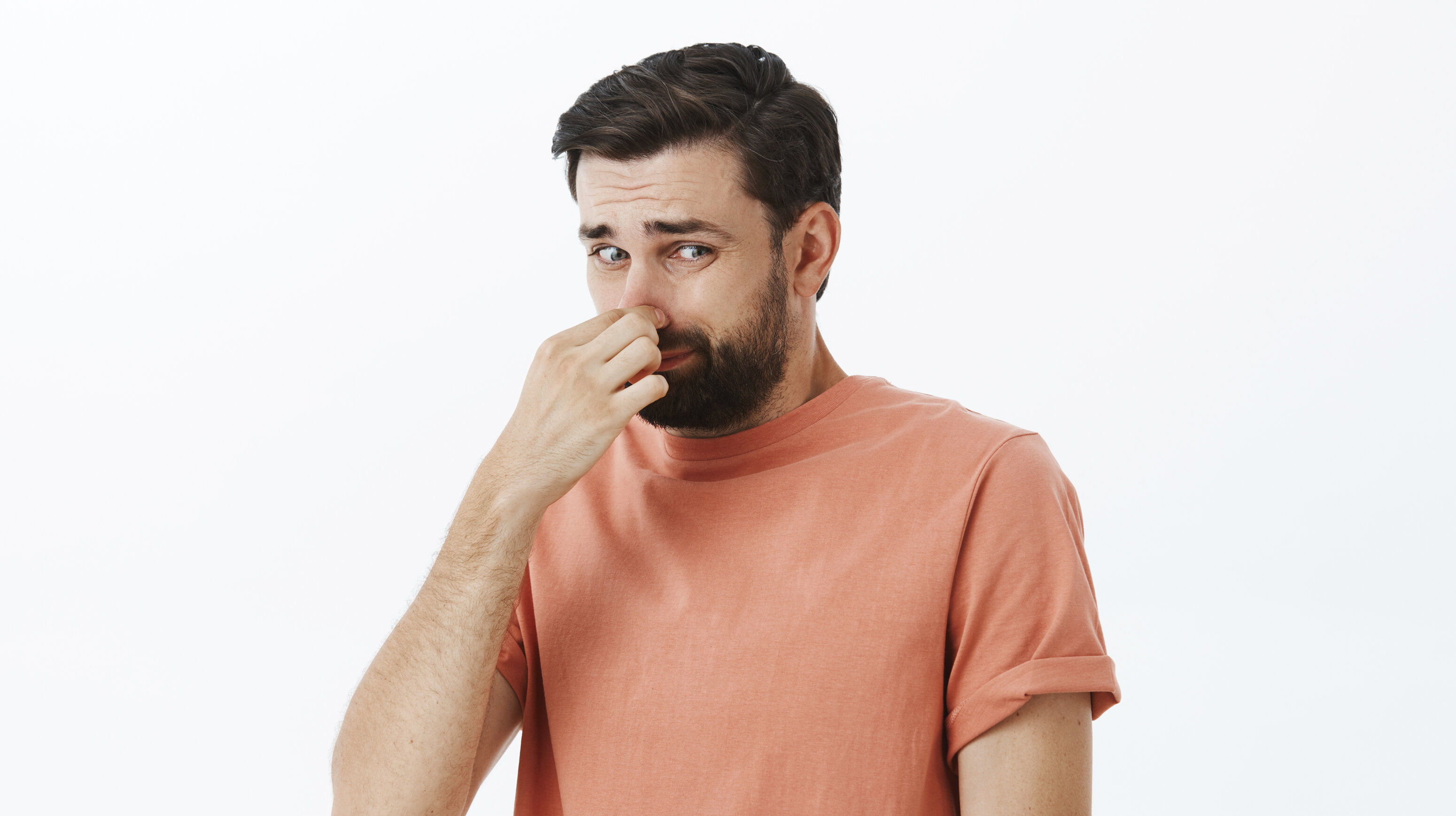 man holding nose from bad smell 